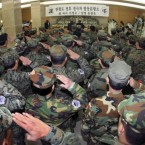 South Korean veterans salute in front of the altar during a memorial service for South Korean marines who were killed in North Korea's bombardment, at a military hospital in Seongnam, South Korea.

 (AP Photo/Korea Pool) 