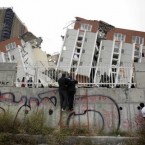 People look at a collapsed building in Concepcion, Chile, Sunday, Feb. 28, 2010. A 8.8-magnitude earthquake hit the country, killing over 500 people.

(AP Photo/ Natacha Pisarenko)
