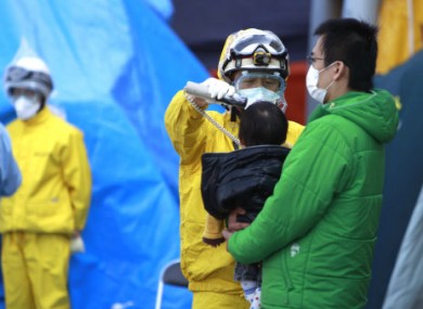 People evacuating from area near the Fukushima nuclear facilities in Japan being tested for radiation exposure yesterday.