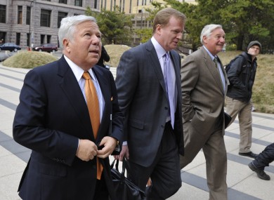 New England Patriots owner Robert Kraft, left, and NFL commissioner Roger Goodell, center, are escorted by NFL security as they arrive at Minneapolis courthouse for mediation talks.