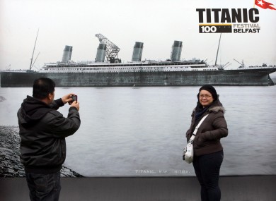 Tourists look at an exhibition in Belfast to mark this year's centenary of the Titanic's launch