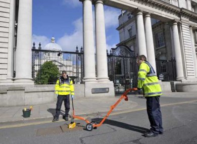 Gardai seal manhole covers outside Government Buildings this morning ahead of the visit of Queen Elizabeth next week.