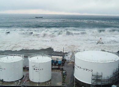Handout photo from TEPCO showing the tsunami approaching the fuel oil takes of Reactor 5 at the Fukushima plant.