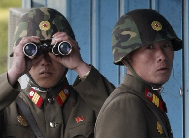 File: North Korean soldiers look over at the South side of the border in Panmunjom in April 2011.