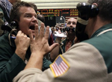 Traders work the crude oil options pit at the New York Mercantile Exchange on Friday. The price of oil has fallen by 10 per cent since Friday morning.