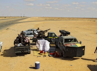 A rebel fighter packs his bed at a checkpoint 80km from Misrata.