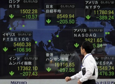 A man looks at an electronic stock board of a securities firm in Tokyo