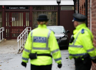 Police stand outside Warrington Coroner's Office earlier.