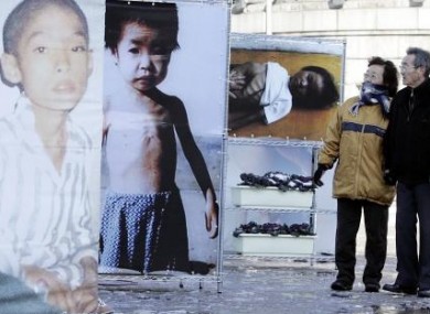 A South Korean couple look at pictures of North Korean famine victims at an exhibition in Seoul in 2005.