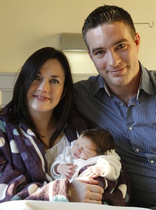 First-born of 2012: Amelie Rose Mitchell, here with her parents Catriona and Neil Mitchell from Churchtown, Dublin, was born at 35 seconds past midnight at the Rotunda Hospital.
