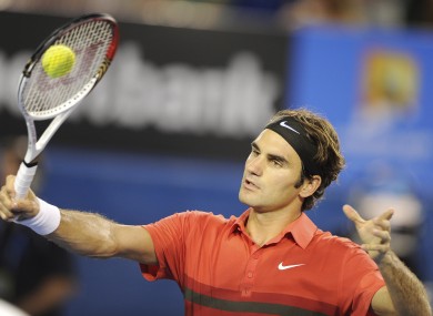 Switzerland's Roger Federer makes a backhand return to Russia's Alexander Kudryavtsev during their first round match at the Australian Open this morning.