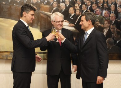 Croatia's president Ivo Josipovic, center, prime minister Zoran Milanovic, left, and the Parliament speaker Boris Sprem make a toast upon hearing unofficial results of the referendum last night