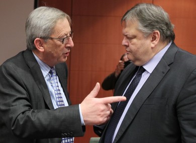 Jean Claude Juncker, left, talks to Greek finance finister Evangelos Venizelos.
