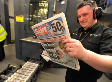 A printer reads one of the first copies of the Sun on Sunday hot off the press last night.