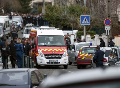 Police officers and firefighters gather at the site of a shooting in Toulouse