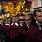 Worshipers, one of them with his eyes covered as part of a promise, carry on their shoulders a figure of Jesus Christ as they take part in a procession in Malaga (AP Photo/Emilio Morenatti)