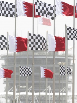 Dust envelops the Bahraini flag-topped tower of the Bahrain International Circuit in Sakhir, Bahrain.