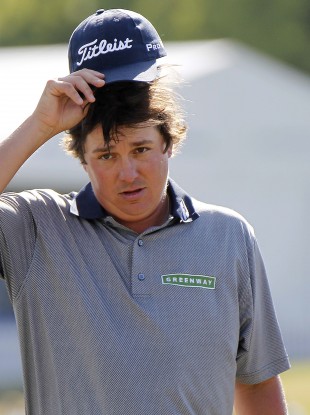 Jason Dufner lifts up his cap after making birdie yesterday.