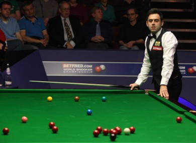 Ronnie O'Sullivan watches the cue miss a red during a snooker in his match with Australia's Neil Robertson earlier today.