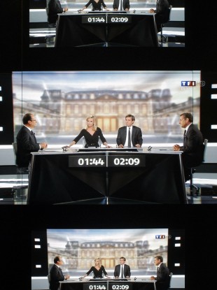 A wall screen shows the televised debate at the TF1 television studio, in Boulogne-Billancourt, outside Paris.