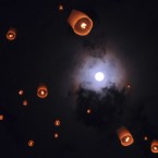 In this late Sunday, May 6, 2012 photo, lanterns release by Buddhist worshippers fly as full moon is seen in the background during a procession commemorating Waisak day which marks the birth, death and enlightenment of Buddha at the 9th century Borobudur temple in Magelang, Central Java, Indonesia. (AP Photo/Slamet Riyadi)
