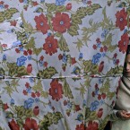 An Afghan refugee girl, looks on while standing the doorway of her home in a slum area on the outskirts of Islamabad, Pakistan, Monday, May 7, 2012. (AP Photo/Muhammed Muheisen)
