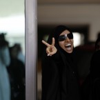 A Bahraini anti-government protester gestures outside a Manama, Bahrain, courthouse on Tuesday, May 8, 2012, where a defense lawyer says a civilian court has begun proceedings to re-examine convictions against a jailed hunger striker and 20 other activists. (AP Photo/Hasan Jamali)