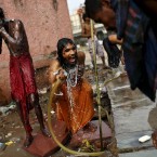Indian Muslim Sufi devotees who are on a pilgrimage to the Ajmer Sharif, a revered Muslim shrine in India's western state of Rajasthan, bathe in New Delhi, India, Tuesday, May 8, 2012. Thousands of Sufi devotees from different parts of the country annually travel to the shrine of Sufi Muslim saint Hazrat Khwaja Muinuddin Chishti, for the annual Urs festival observed to mark his death anniversary.(AP Photo/Kevin Frayer)