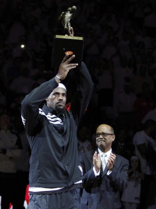 Miami Heat forward LeBron James holds up his NBA MVP trophy.