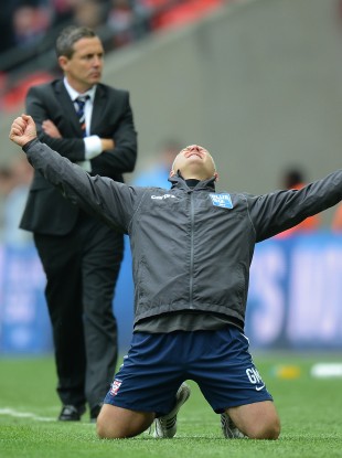 York City's manager Gary Mills celebrates promotion from the BlueSquare Bet Premier Division as Luton manager Paul Buckle looks on.