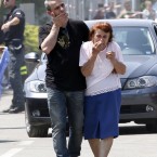 People react in front of the destroyed BBG industrial mouldings building in Mirandola, northern Italy today. A magnitude 5.8 earthquake struck the same area of northern Italy stricken by another fatal tremor on May 20. (AP Photo/Luca Bruno)