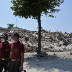 Italian firefighters walk in front of collapsed buildings in Cavezzo, northern Italy today. A magnitude 5.8 earthquake struck the same area of northern Italy stricken by another fatal tremor on May 20. (AP Photo/Marco Vasini)