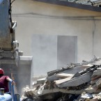 Italian firefighters searches the debris of a collapsed building in Cavezzo, northern Italy today. A magnitude 5.8 earthquake struck northern Italy, killing at least 10 people as factories, warehouses and a church collapsed in the same region still struggling to recover from another deadly tremor nine days ago. (AP Photo/Marco Vasini)