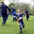 A young fan makes a break for it during a game of tag rugby.