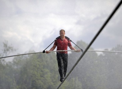 Nik Wallenda performs a walk on a tightrope during a training session in a wind-driven mist at Niagara Falls, New York, on Monday.