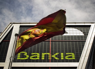 A Spanish flag flies in front of Bankia's headquerters in Madrid