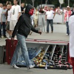 A masked fan walks past a toppled fridge at the Euro 2012 soccer championship Group A match between Poland and Russia in Warsaw, Poland, Tuesday, June 12, 2012. (AP Photo/Gero Breloer)