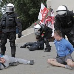 Police arrest soccer fans prior to the Euro 2012 soccer championship Group A match between Poland and Russia in Warsaw, Poland, Tuesday, June 12, 2012. (AP Photo/Gero Breloer)
