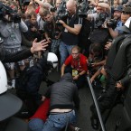 Polish riot police tend to a Russian soccer fan, Russia played Poland in their Euro 2012 Group A soccer tournament in during the Euro 2012 soccer championship in Wardsaw, Poland , Tuesday, June 12, 2012. (AP Photo/Czarek Sokolowski)