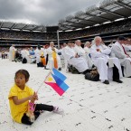 Michaela Gonda, aged 5, from the Philippines sits on the floor inside Croke Park in Dublin during the Statio Orbis, the Liturgy on the final day of the 50th International Eucharistic Congress. Image: Photo: Julien Behal/PA Wire/Press Association Images