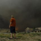 A man stops quickly to get some video before fleeing the approaching flames of the Waldo Canyon fire. (AP Photo/Bryan Oller/PA)