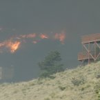 Flames and smoke from the Waldo Canyon Fire surround a home as the fire races down into western portions of Colorado Springs. (AP Photo/Bryan Oller/PA)