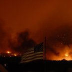 Flames from the Waldo Canyon Fire cause the western side of Colorado Springs to glow as several structures burn. (AP Photo/Bryan Oller/PA)