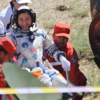 Female astronaut Liu Yang is carried after coming out of the re-entry capsule of the Shenzhou-9 spacecraft (Photo by tonglaga/Chinafotopress)