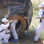 Chinese engineers work on the re-entry capsule (Photo by tonglaga/Chinafotopress)