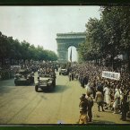 Crowds of French patriots line the Champs Elysees to view Allied tanks and half tracks pass through the Arc du Triomphe, after Paris was liberated on August 25, 1944