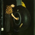 Inspecting of landing wheel of the transport planes at Willow Run