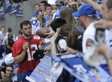 New Colts QB Andrew Luck signs autographs after a team training session.