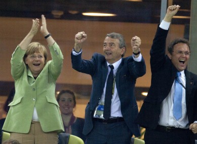 Angela Merkel, left, German Soccer Federation President Wolfgang Niersbach and German Interior Minister Hans-Peter Friedrich, right.