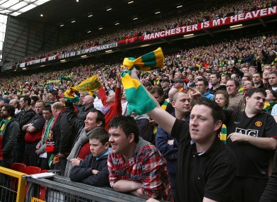 Manchester United fans wave green-and-gold scarves - the club's colours when it was first founded - in protest at the Glazer family's ownership of the club.